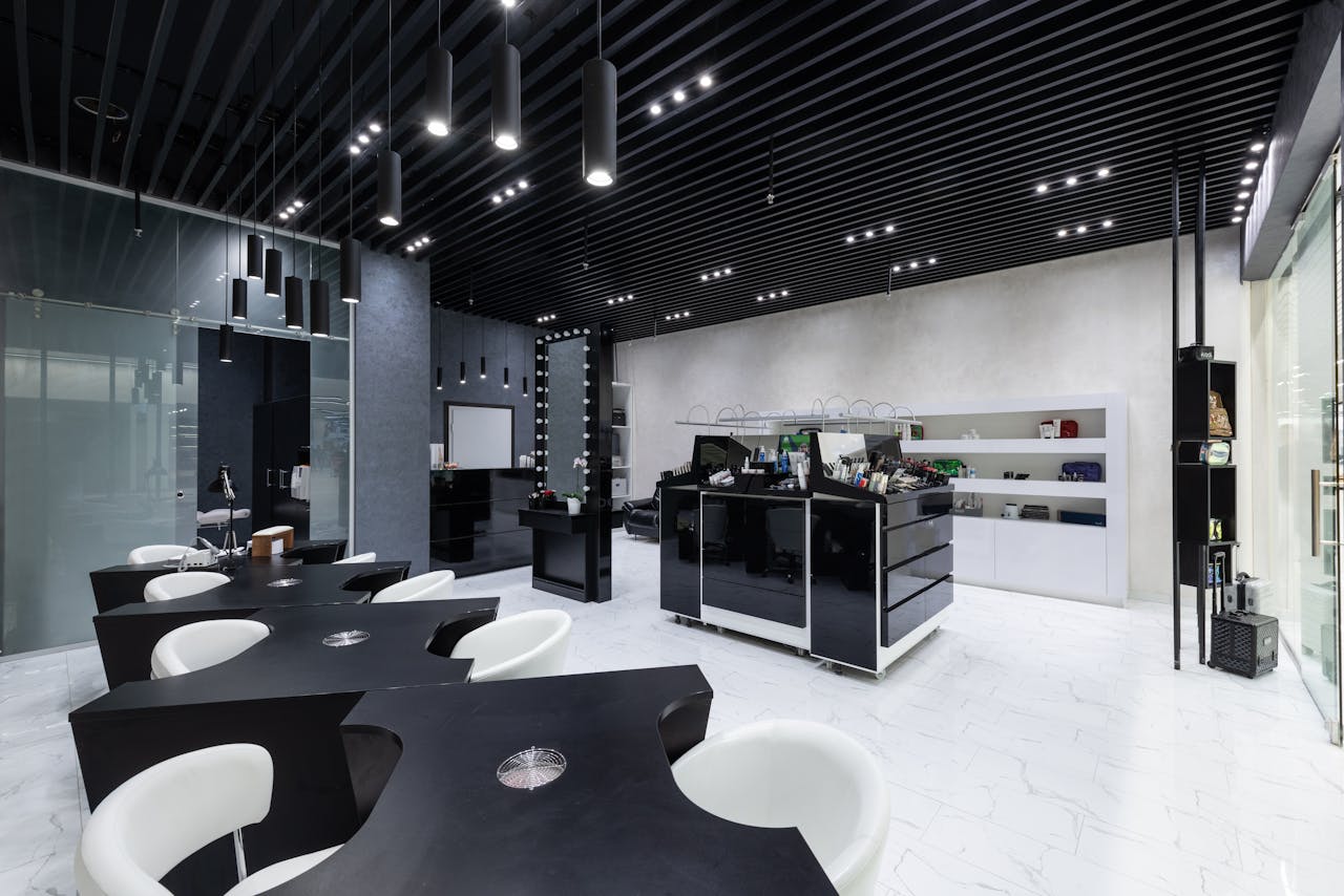 Sleek beauty salon interior with contemporary furniture and lighting design.